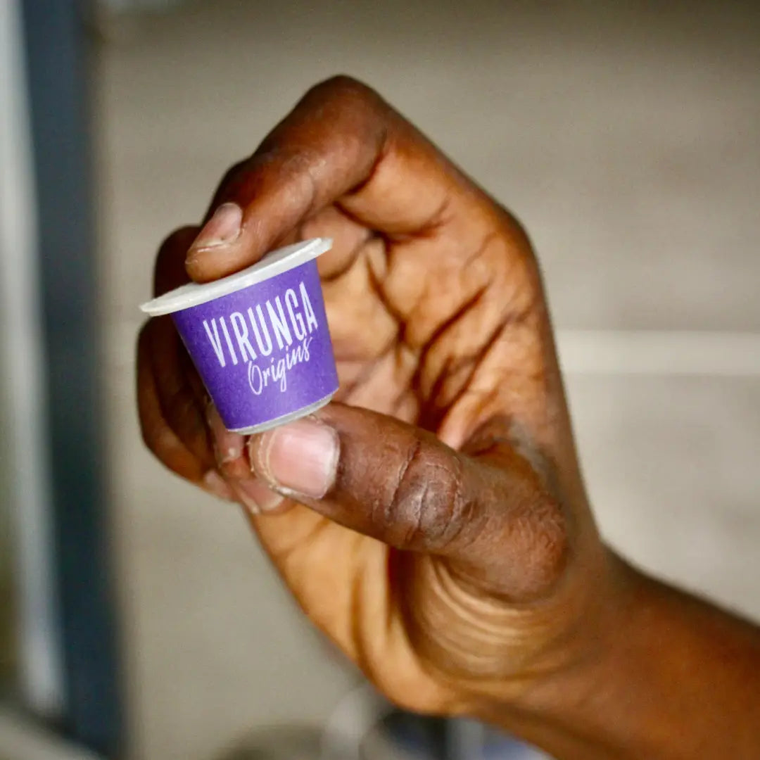 hand holding a Rounded Coffee Capsules